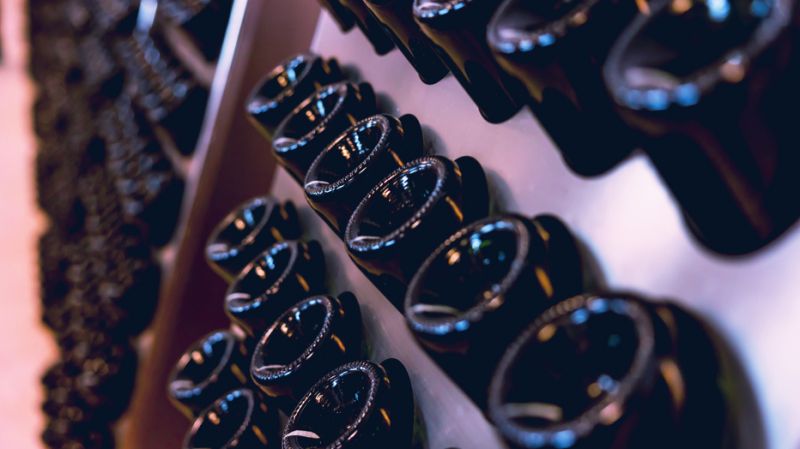 Rows of wine bottles showcased during a Grands Crus event, symbolizing the unique selling points of custodian banks.