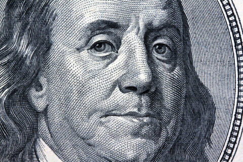 Close-up of Benjamin Franklin on a US $100 bill, symbolising financial planning and wealth management.