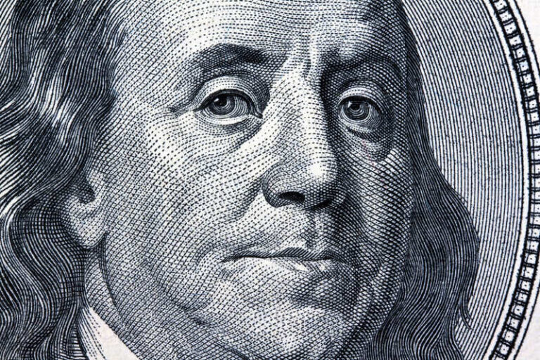 Close-up of Benjamin Franklin on a US $100 bill, symbolising financial planning and wealth management.