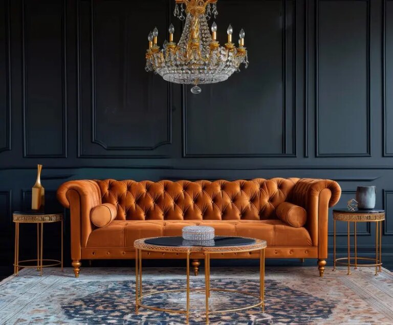 Ein elegantes orangefarbenes Tuftingsofa mit einem Kristalllüster und goldfarbenen Beistelltischen in einer raffinierten Lounge-Einrichtung. Warum eine offene Architektur besser ist