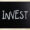 Chalkboard with the word "Invest" written in white letters, symbolizing discretionary advisory investment choices.