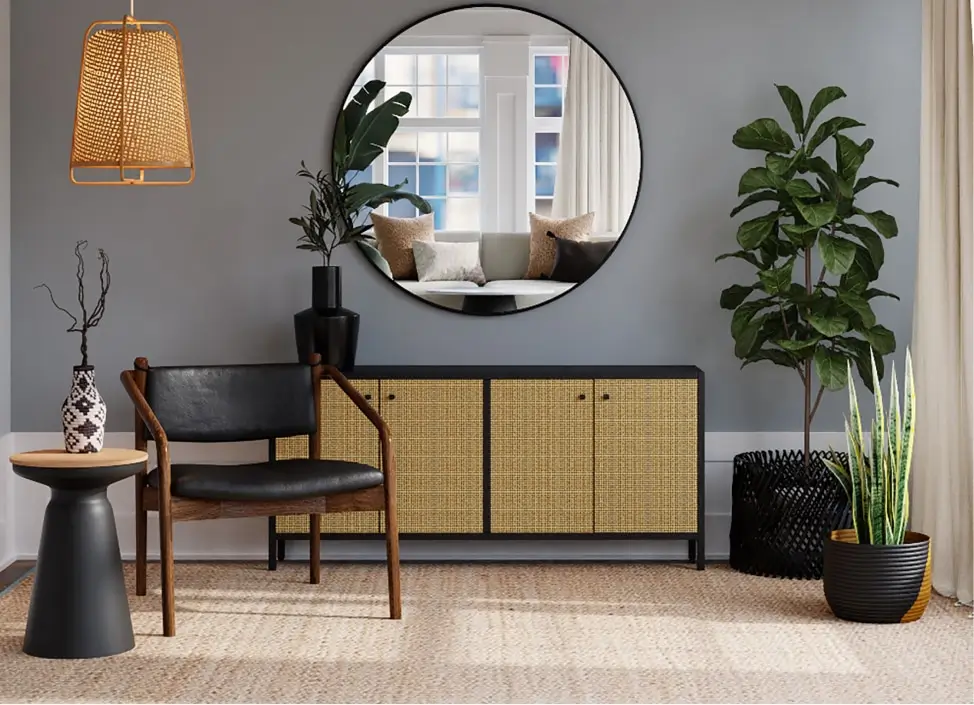 Stylish living space with wooden cabinet, leather chair, large round mirror and green plants – symbolising transparency, open architecture and continuity in Swiss independent wealth management.