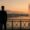Man in suit overlooking Lake Geneva and Jet d’Eau fountain at sunrise, symbolising future of Swiss wealth management.