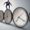 Businessman balancing on clocks, symbolising time, pressure, and escaping banking politics