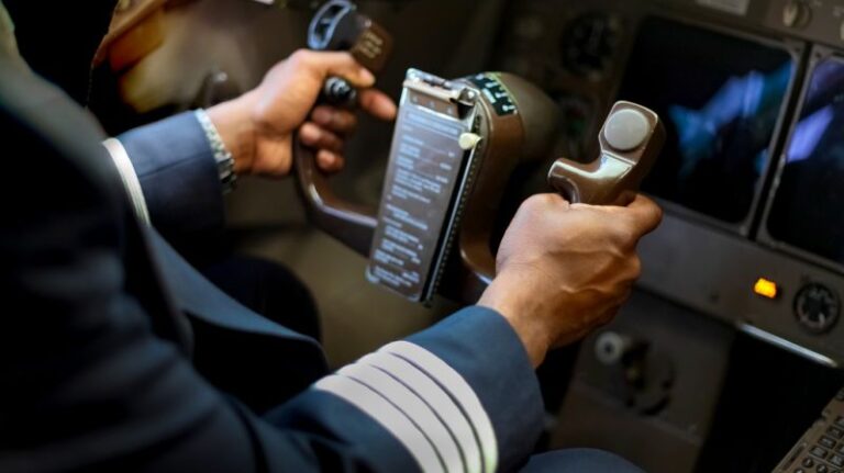 Pilot holding plane yoke, symbolising steering one’s own financial journey