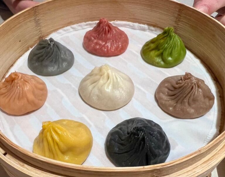 Assorted colourful dumplings in bamboo steamer, symbolising variety and choice in open architecture investment models