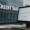 Credit Suisse office view with screen showing financial dashboard in focus