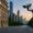 Swiss bank building with surveillance camera and modern city skyline in background