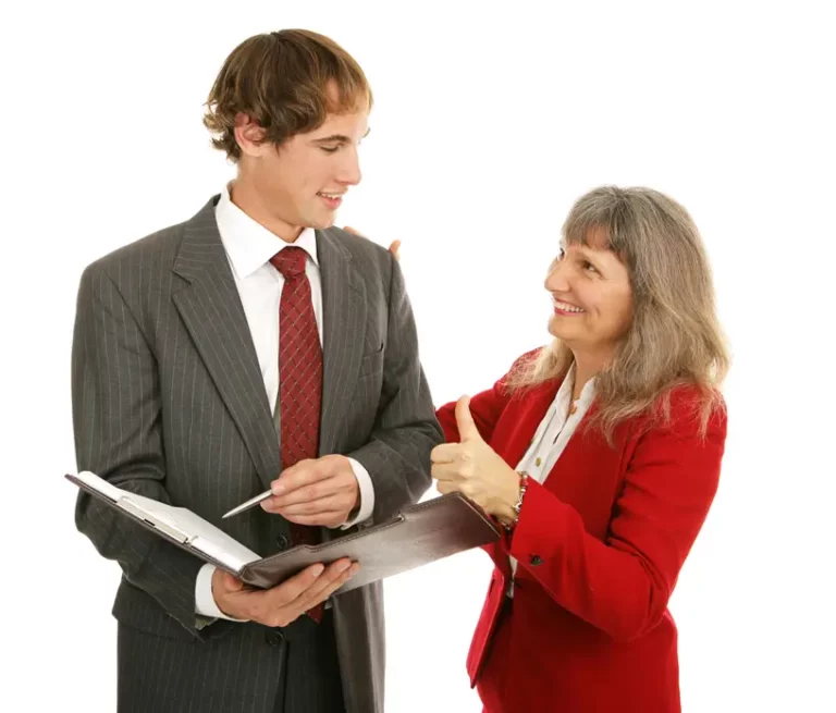 Business mentoring concept with senior professional guiding younger colleague reviewing documents, symbolising leadership development, coaching, and knowledge transfer.