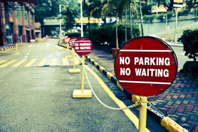 'No parking, no waiting' sign on a closed street